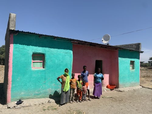 people standing in front of house